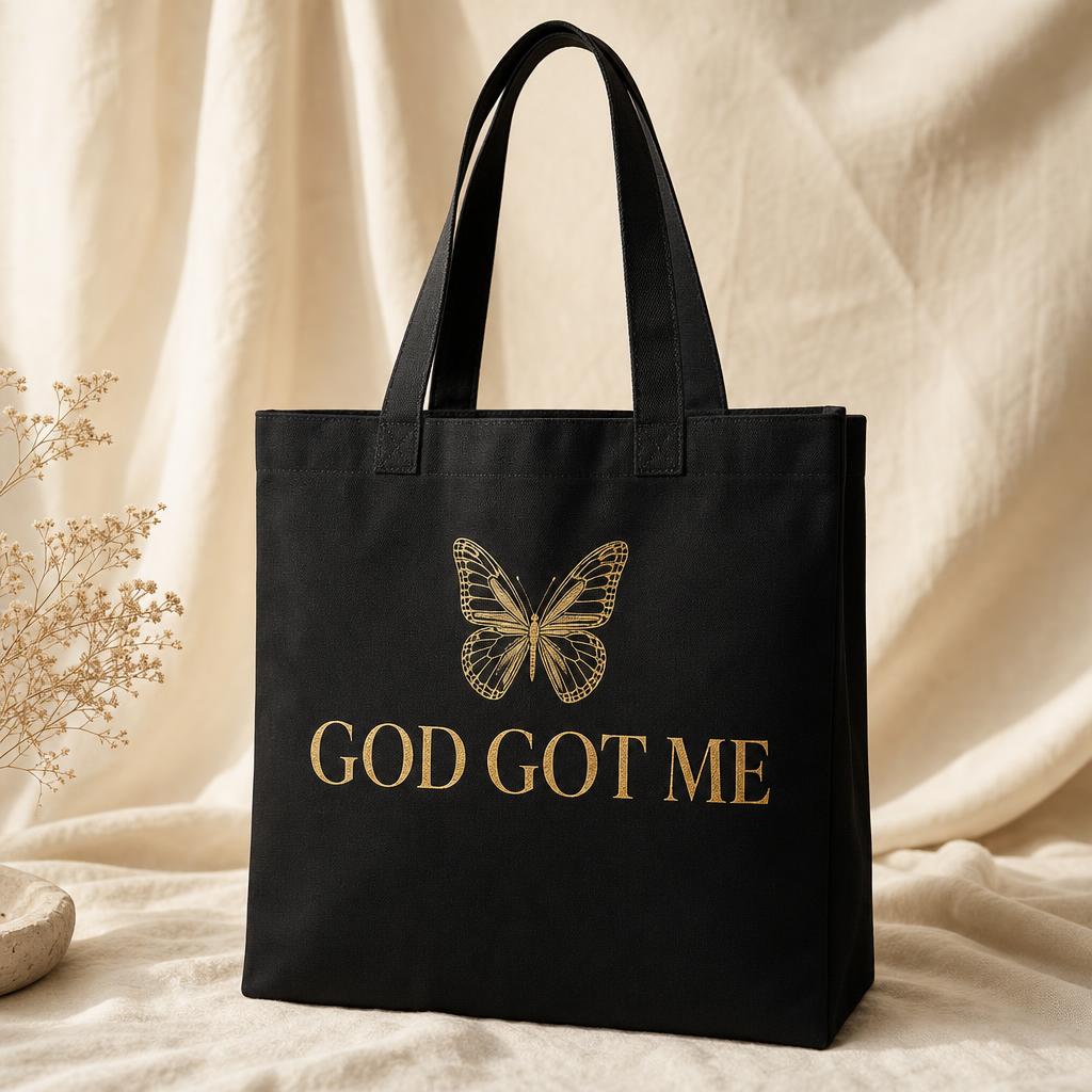 God Got Me Tote design shown on black apparel